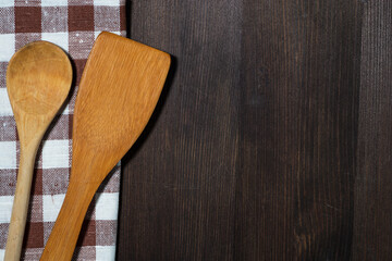 dishcloth, wooden spoons, wooden background, closeup