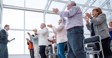 Speaker giving a talk in conference hall at business event. Audi
