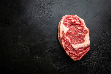 Raw fresh meat Ribeye beef Steak on black background, top view