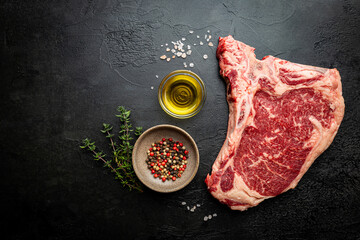 Raw fresh meat T-bone beef Steak on black background, top view