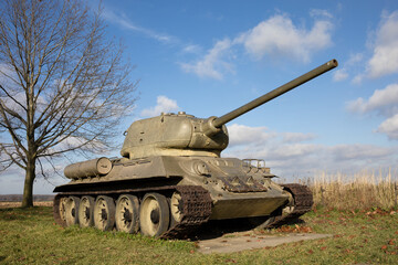 Old aged soviet tank from second world war - armored fighting vehicle with continuous track and cannon.