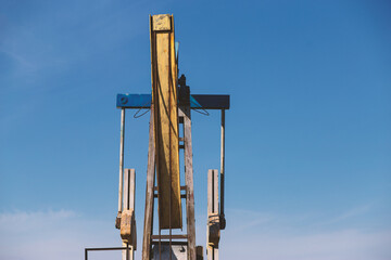 pumpjack close up against the sky