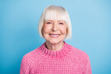 Photo portrait of smiling elderly woman isolated on pastel blue colored background