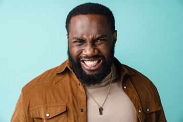 Angry upset african man standing isolated