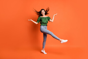 Full length photo of charming pretty lady dressed off-shoulders blouse dancing showing scales isolated orange color background