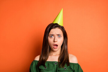 Photo of shocked sad lady dressed green off-shoulders blouse birthday headwear open mouth isolated orange color background