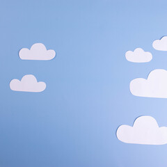 white paper clouds on plain light blue background. cope space