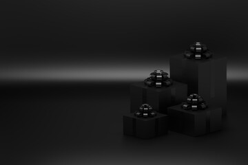 Four presents in boxes with glossy bows on black background. Image with blank copy space