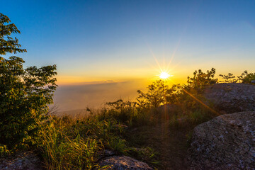 Beautiful sunset with sunstar view point from Khao Luang Sukhothai, Ramkhamhaeng National Park , Sukhothai Thailand.