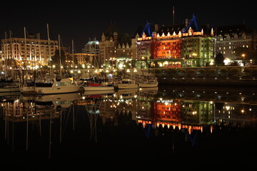 Fototapeta na wymiar View of Victoria Harbor with sailing boats and yachts during night in Vancouver island, BC, Canada