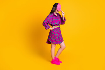 Full size profile photo of nice cute brunette teen stand cover face wear pink dress cap sneakers isolated on yellow background