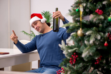 Young man celebrating Christmas alone at home