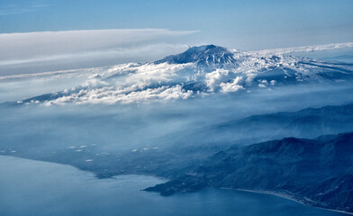 Fototapeta premium view from the airplane window of the mountains and clouds.