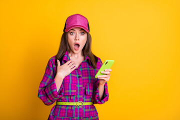 Portrait of attractive lady cant believe impressed open mouth violet hat isolated on yellow color background
