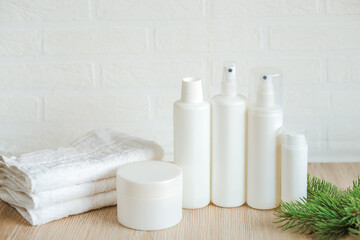 Spa composition with white towels, bottles and containers on the table, Spa set