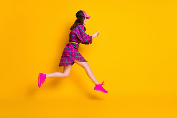 Fototapeta na wymiar Full size profile photo of beautiful model jump type sms style magenta plaid outfit isolated on yellow color background
