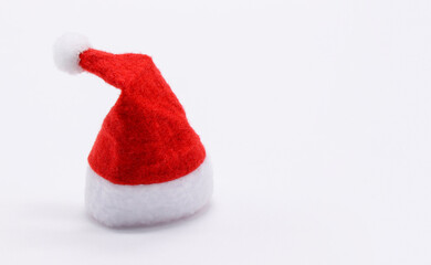 Obraz na płótnie Canvas Santa's red hat close-up on a white background. Free space for text.