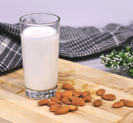 Almond milk with almond on a wooden table