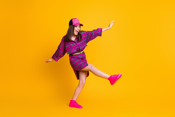 Fototapeta na wymiar Full size portrait of young person dance have fun looking empty space headwear isolated on yellow color background