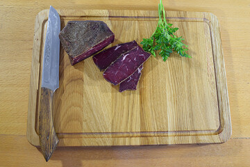 Basturma (beef jerky) on a cutting board.