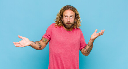 blonde man shrugging with a dumb, crazy, confused, puzzled expression, feeling annoyed and clueless