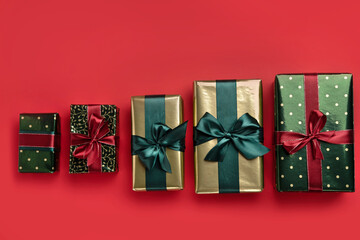Christmas background with gift boxes with satin ribbons  on red background. Trendy design in color of 2021. Top view.
