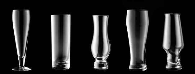 Different empty glasses on dark background