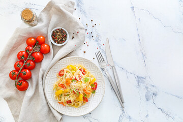 Plate with tasty pasta primavera on white background