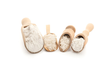 Scoops with rice and flour on white background