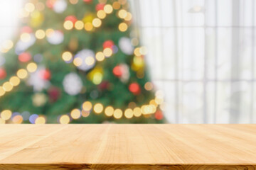 Fototapeta na wymiar Empty table top with blurred Christmas tree with bokeh light background