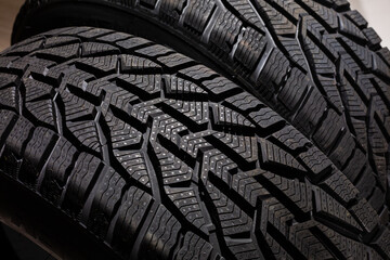 Closeup car tire isolated on black background. Wet with drops wheel against black