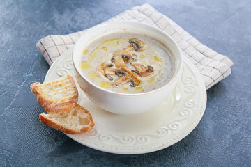 Bowl of tasty mushroom cream soup on  color background