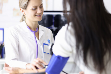 Female doctor measures blood pressure to patient. Blood pressure symptoms concept
