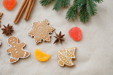 xmas, Christmas, New year texture with fur tree branch, gingerbread, cinnamon, anise, marmalade on craft paper background, place for text, top view