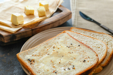 Toasts with butter and spice on table, closeup