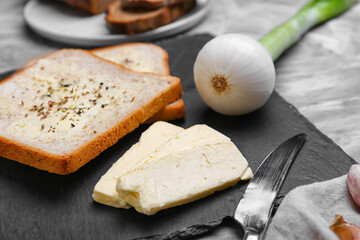 Butter, toasts and onion on table