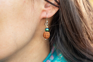 Closeup of female ear wearing beautiful earring