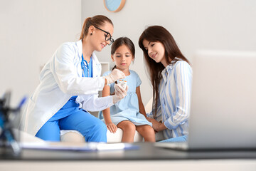 Diabetic girl with mother visiting doctor in clinic