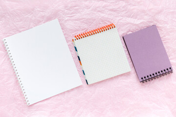 Three open blank notepads on pink backgrounds. Template with copy space for your text