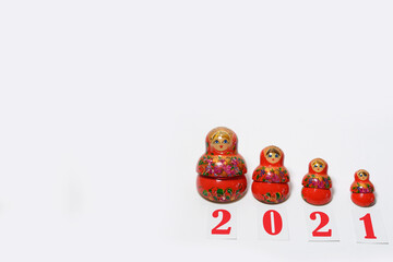 red christmas numbers 2021 combined with russian nesting dolls on isolated white background. russian doll matryoshka Holiday decoration or postcard concept with top view and copy spac