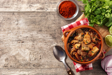 Traditional mondongo or el menudo soup on wooden table