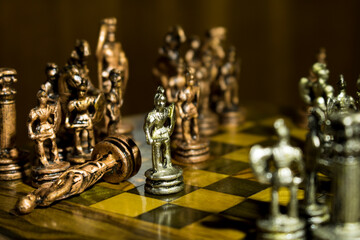 Classic Roman chess with bronze and silver pieces, king, pawn kills