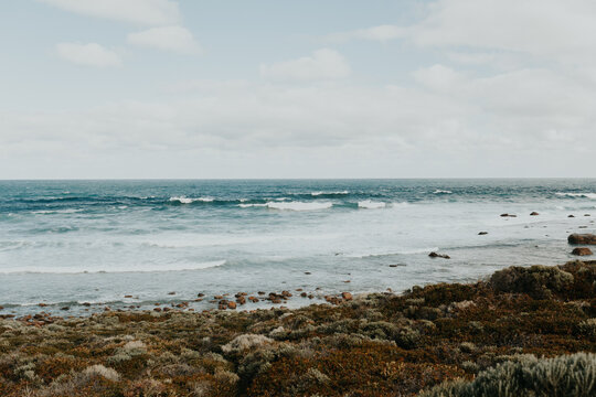 Rugged coast with long waves on sunny day
