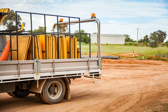 Back of a truck full of roadwork signs on a construction site