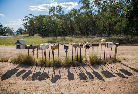 Row of country mailboxes on rural dirt road