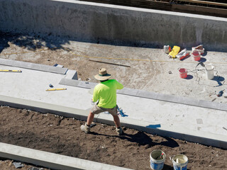 Concrete mixing and pool building with cement by hand with tradies