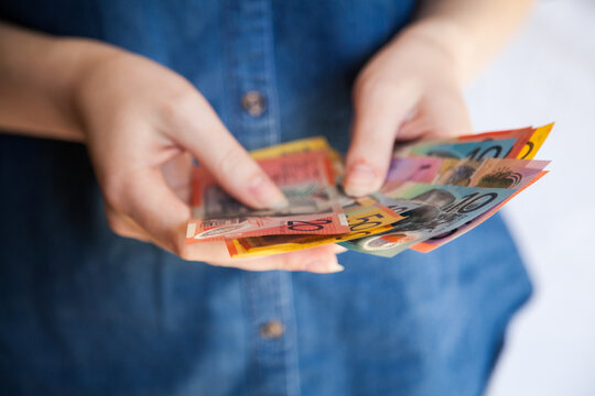 Hands counting Australian money notes