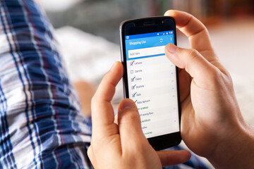 Grocery list on a phone app - online shopping from home concept