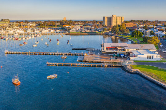Aerial view a bay side yacht club with long jettys out over the water