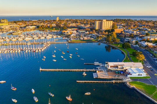 Aerial view a bay side yacht club with long jettys out over the water